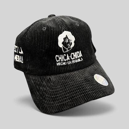 Raree Finds black corduroy strapback hat with white Chica~Chida Hecho en Tequila embroidery and brass buckle closure.