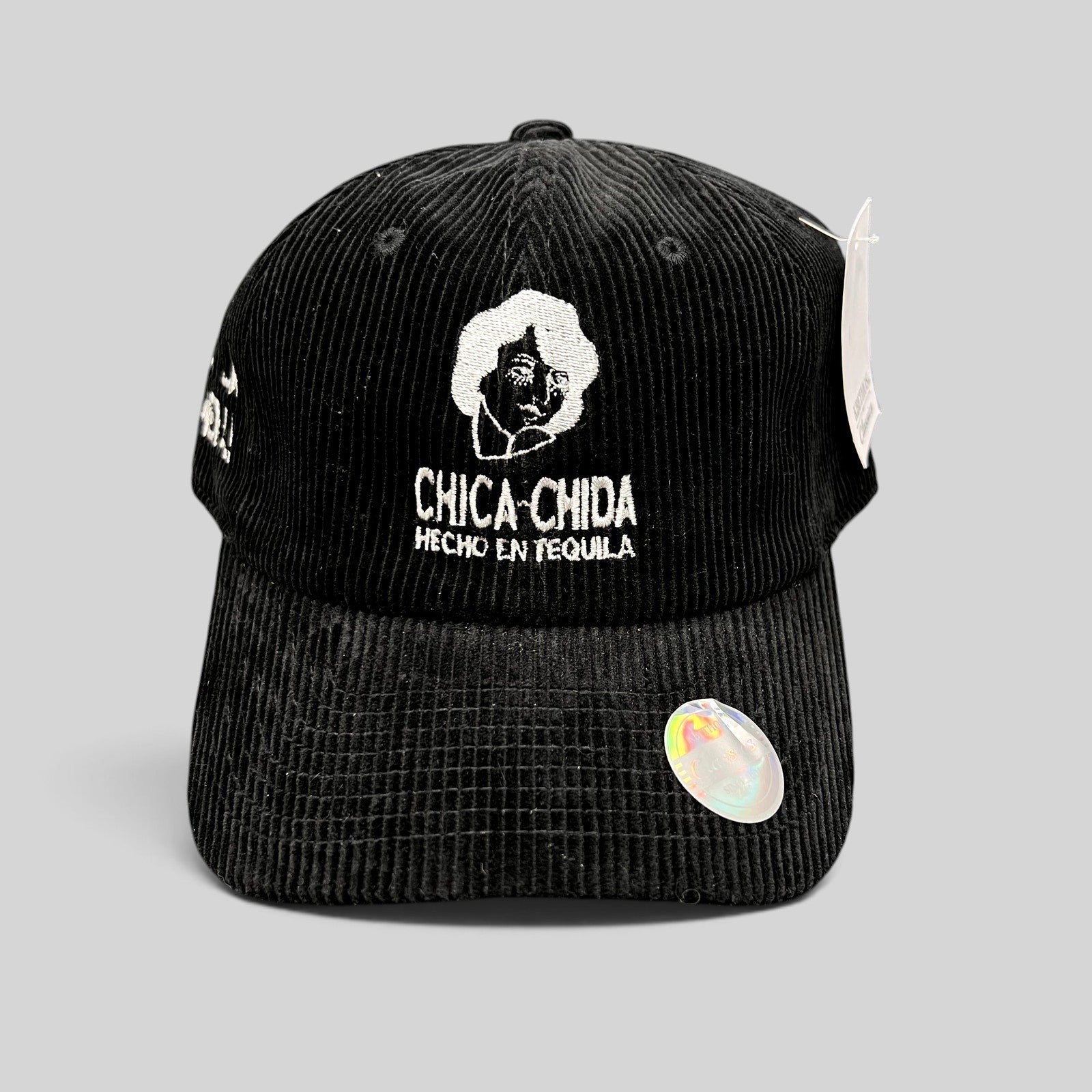 Raree Finds black corduroy strapback hat featuring white embroidered Chica~Chida logo and Hecho en Tequila text.