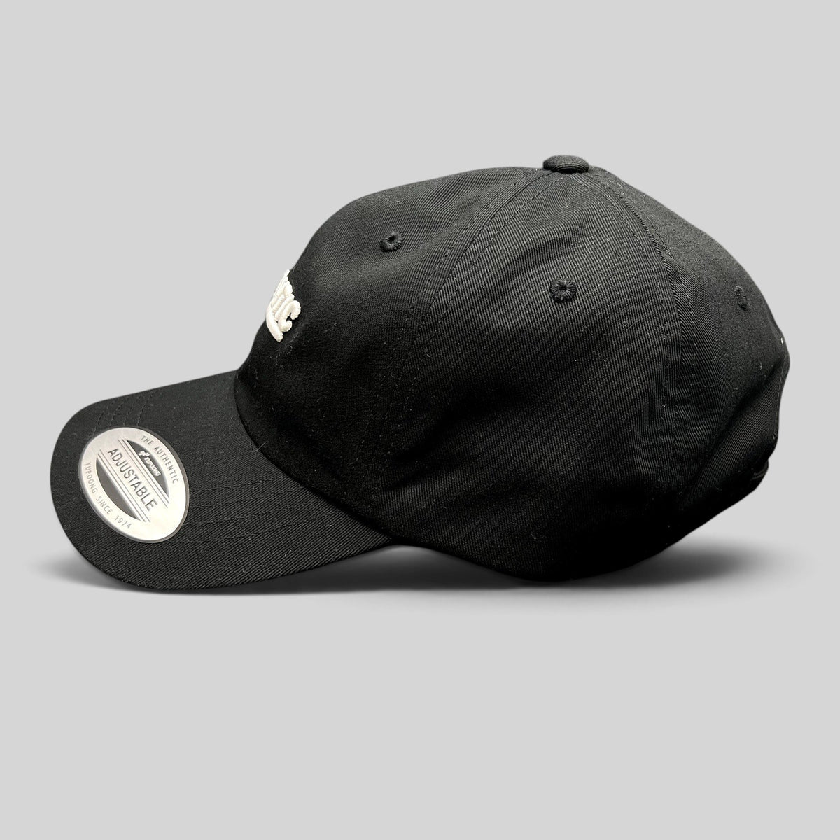 Raree Finds black cotton Yupoong Classics dad cap with white script logo embroidery and adjustable strapback closure