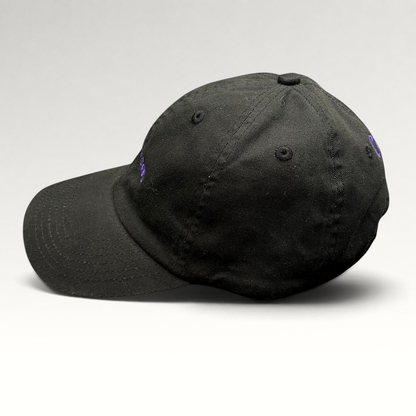 Raree Finds black cotton twill dad hat with purple No Notes embroidery and adjustable brass buckle strapback closure.