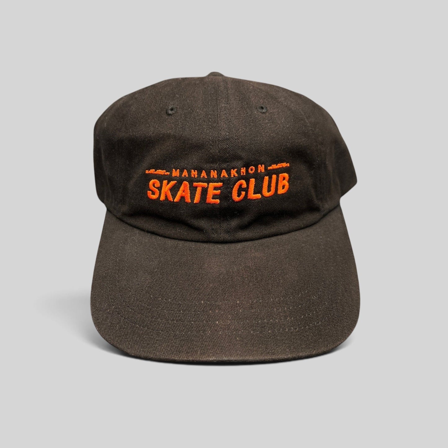 Raree Finds black cotton strapback hat with orange Mahanakhon Skate Club embroidery on an unstructured crown