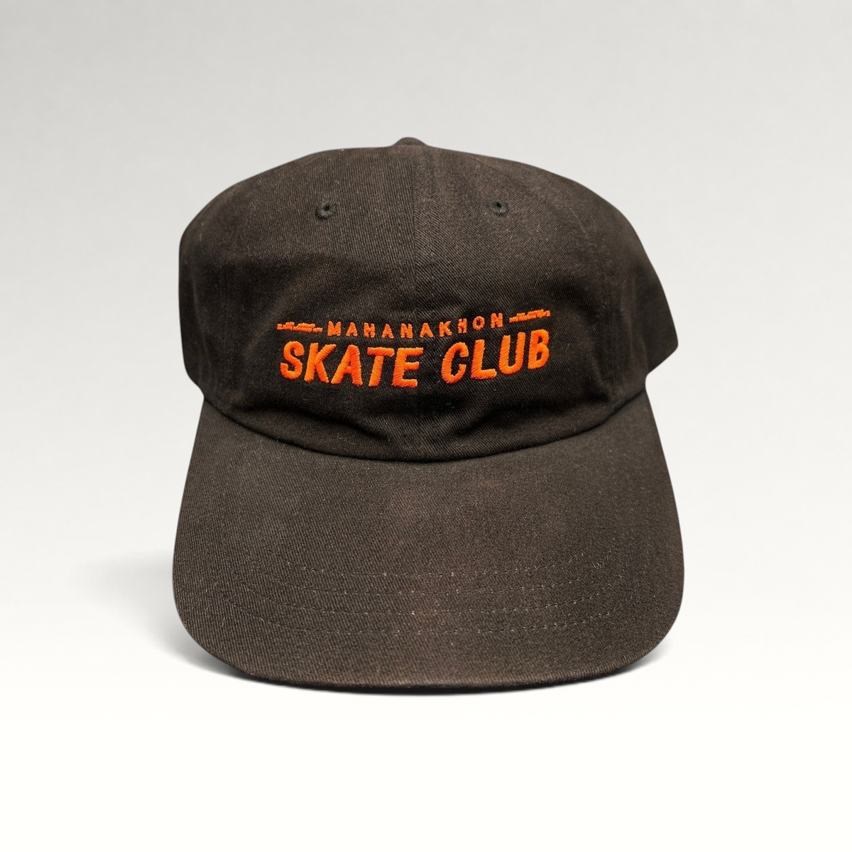 Raree Finds black cotton strapback hat with orange Mahanakhon Skate Club embroidery on an unstructured crown