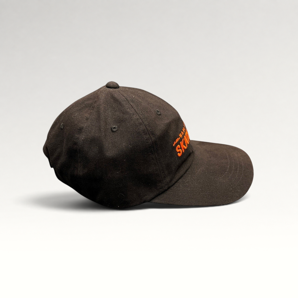Raree Finds black cotton strapback hat with orange Mahanakhon Skate Club embroidery on an unstructured crown