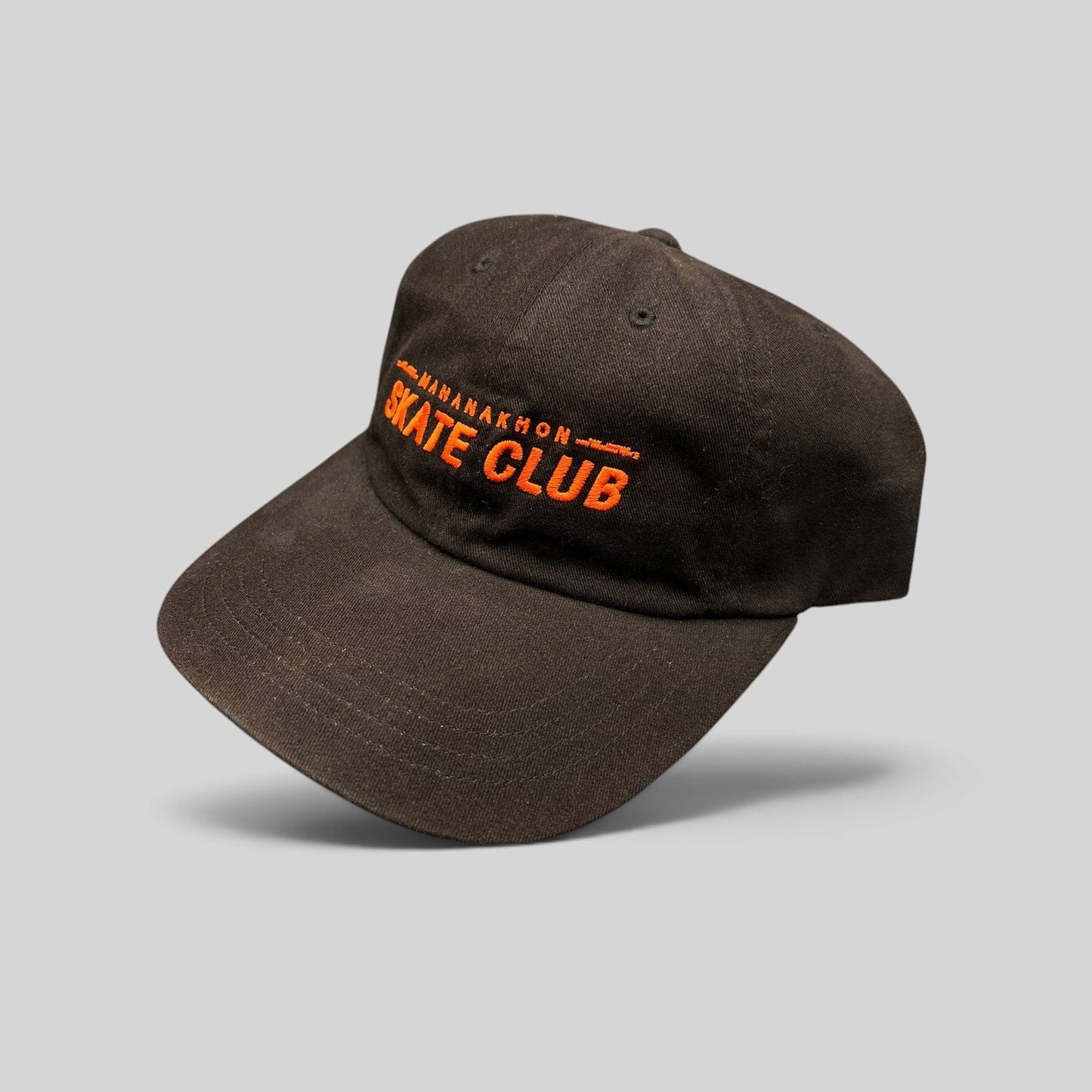 Raree Finds black cotton strapback hat with orange Mahanakhon Skate Club embroidery on an unstructured crown