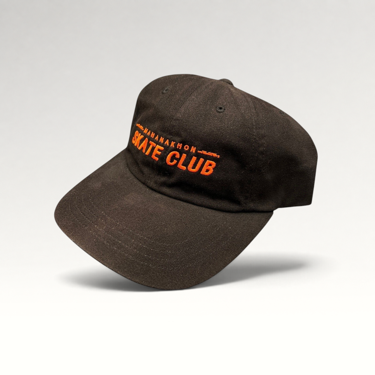 Raree Finds black cotton strapback hat with orange Mahanakhon Skate Club embroidery on an unstructured crown