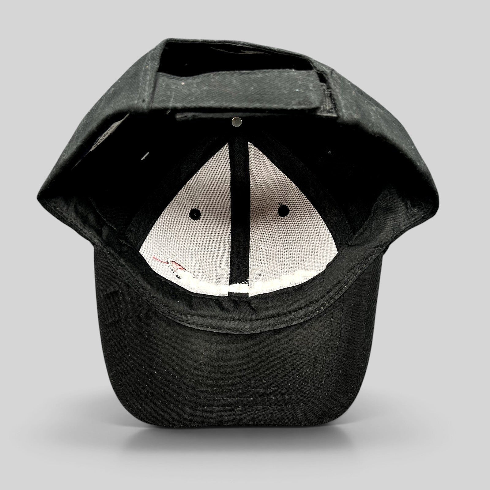 Raree Finds black cotton strapback cap interior view showing the six-panel construction and adjustable velcro strap