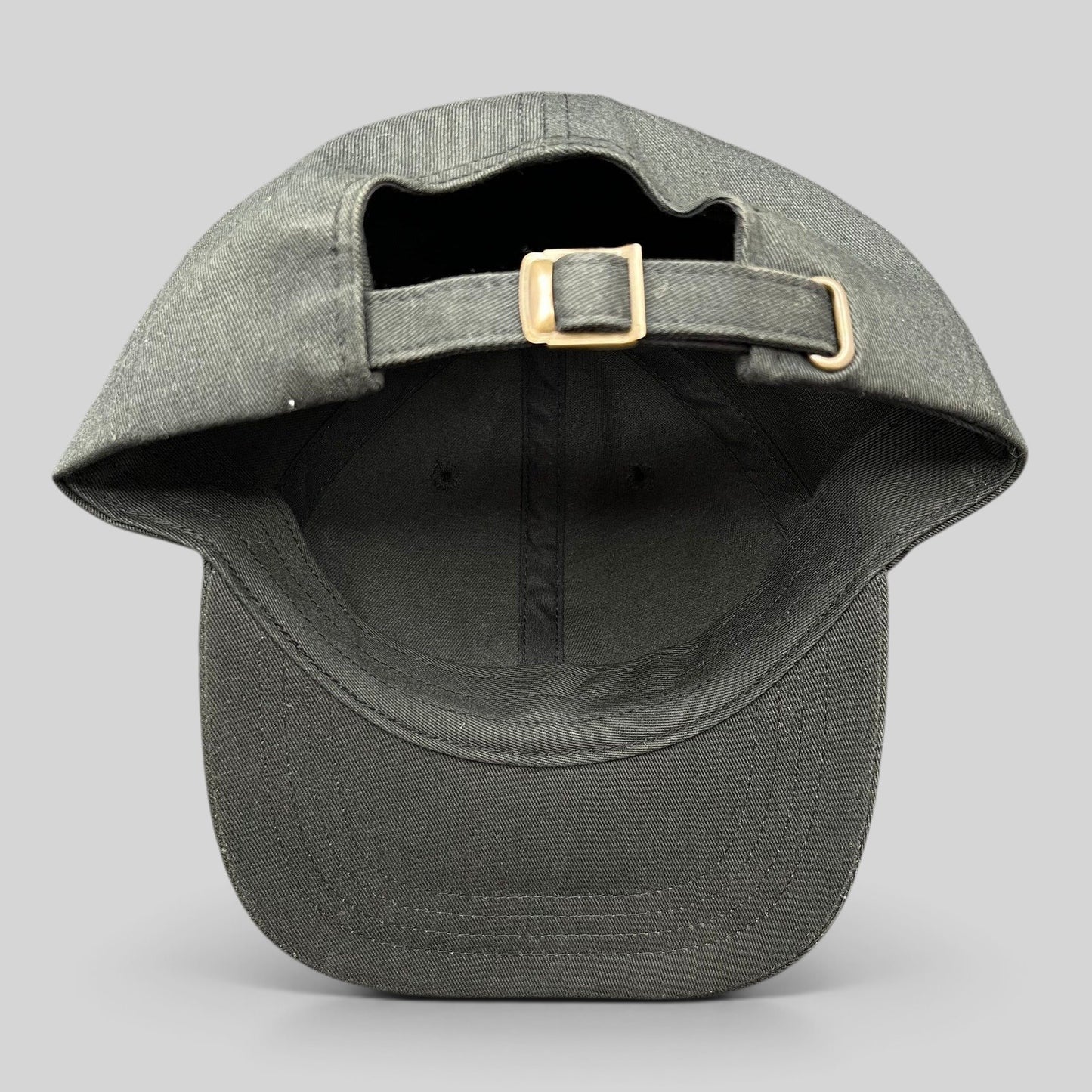 Raree Finds black cotton strapback hat with adjustable metal buckle closure, showing the back view.