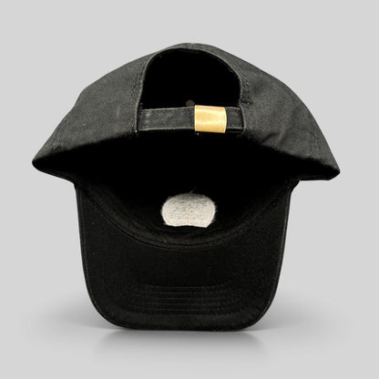 Raree Finds black cotton strapback hat with adjustable brass buckle, showing the back view of the cap.