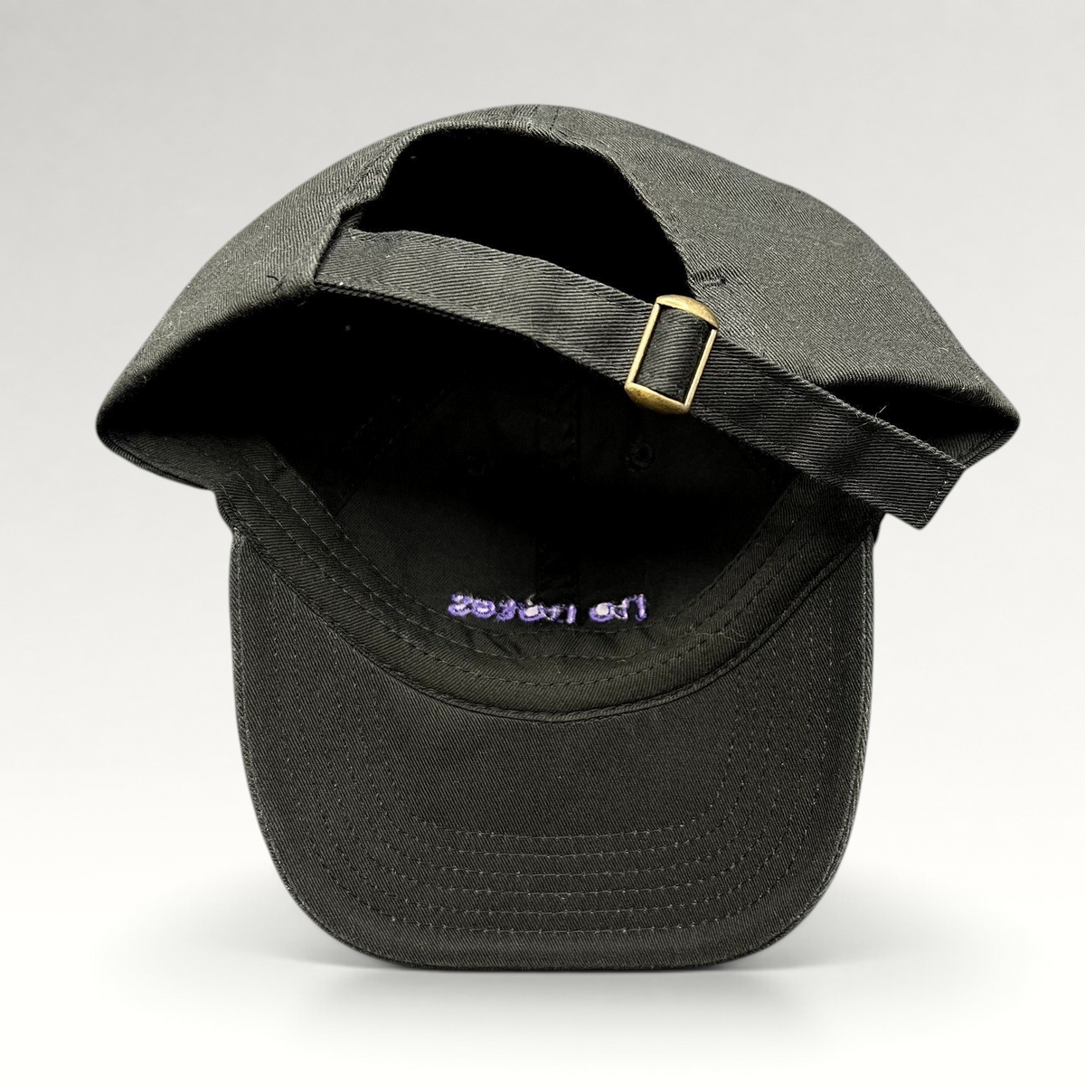 Raree Finds black cotton twill dad hat with adjustable brass buckle strapback and purple embroidered interior detail