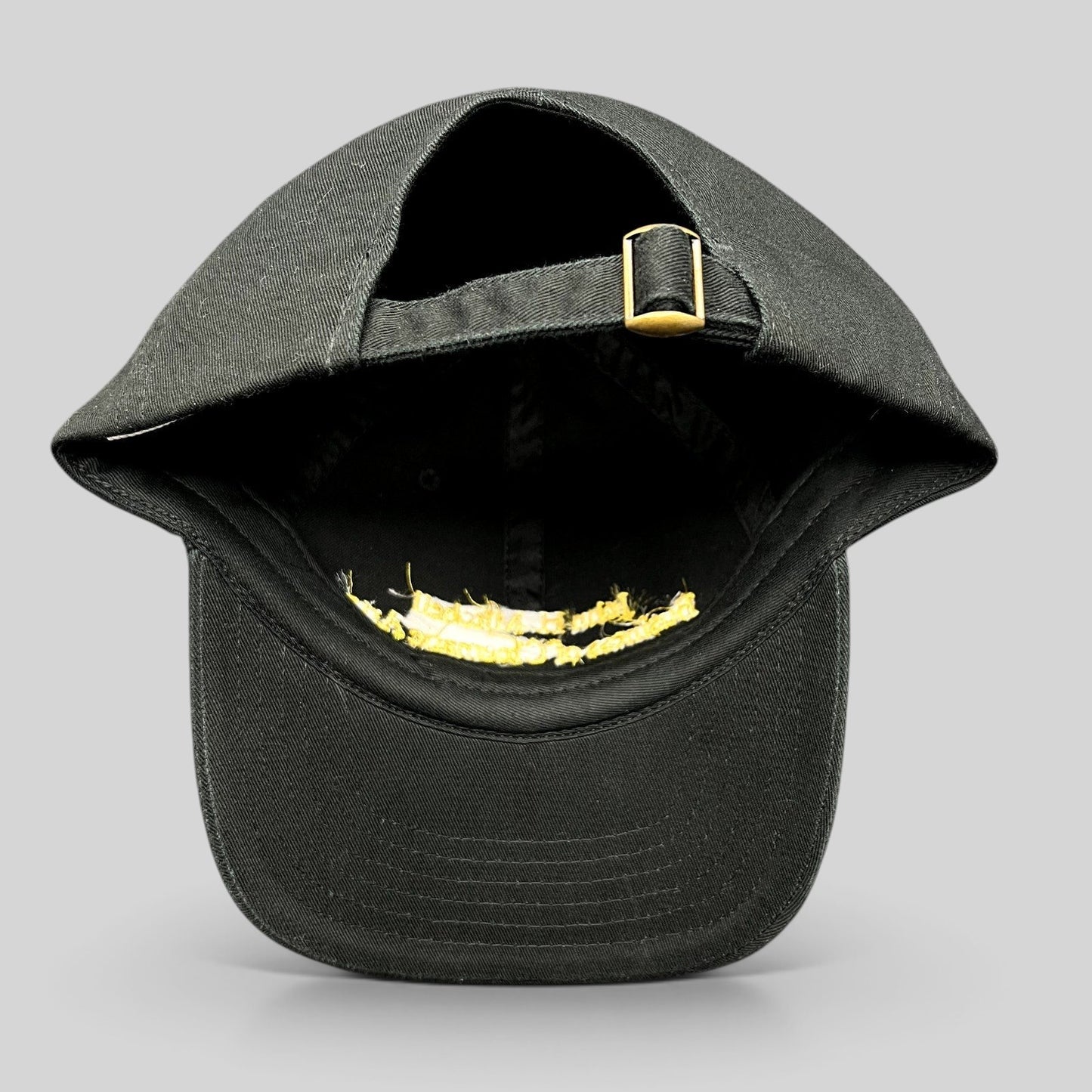 Raree Finds black cotton strapback hat with gold buckle detail, showing the adjustable back strap and interior