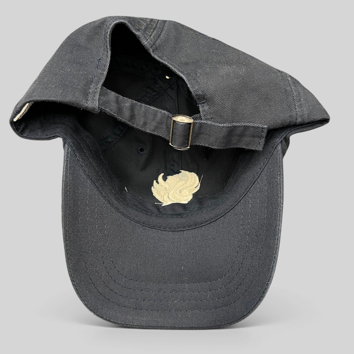 Raree Finds black cotton strapback hat from The Phoenician Scottsdale showing the adjustable metal buckle closure