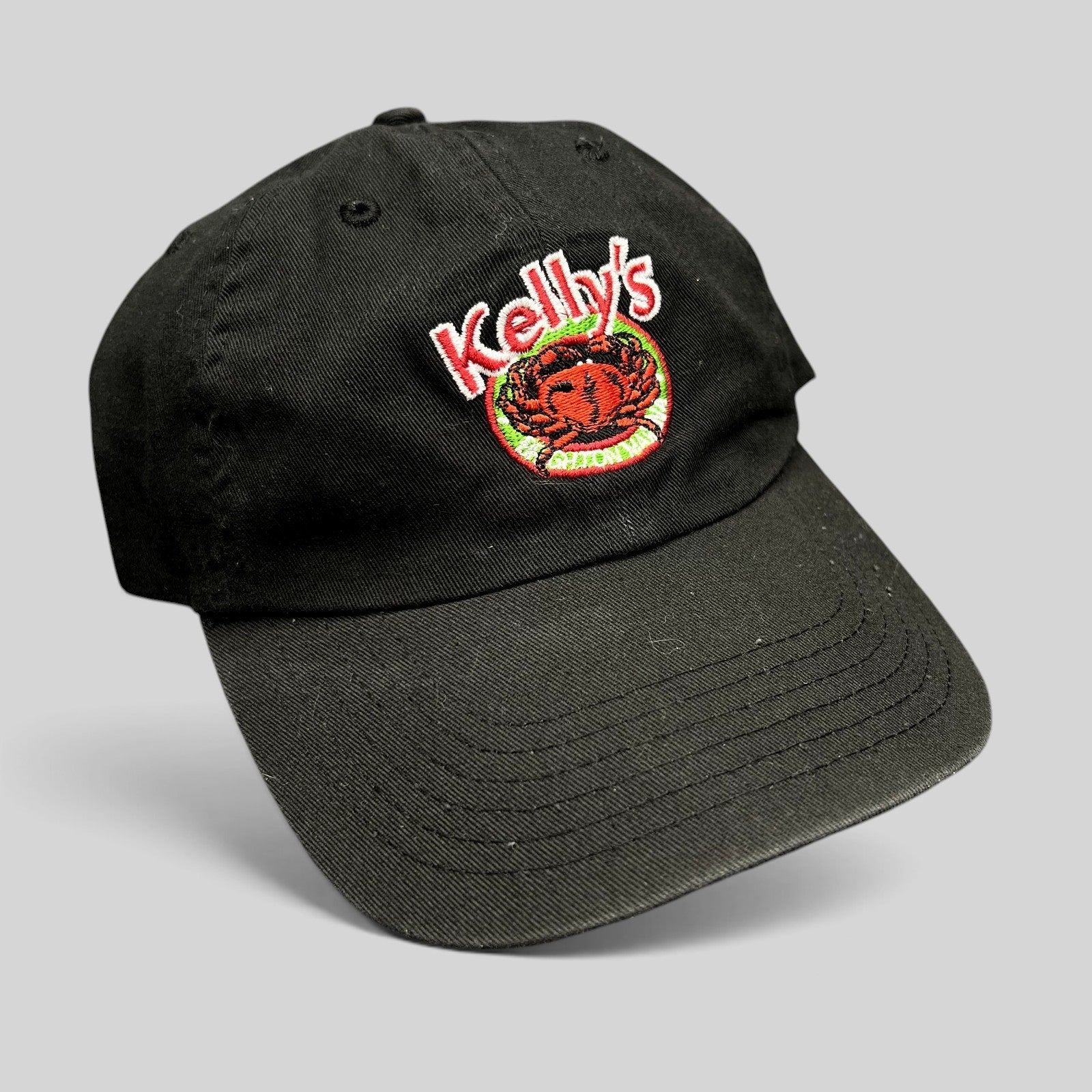 Raree Finds black cotton strapback hat with Kelly's Restaurant crab logo embroidery and curved brim