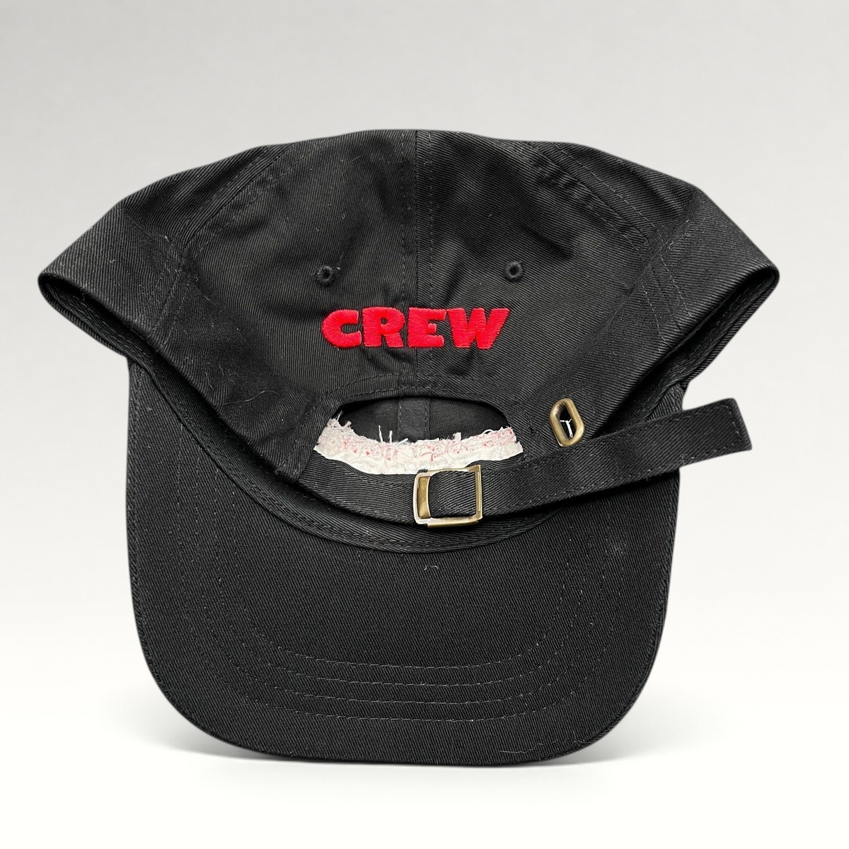 Raree Finds black cotton strapback hat with red embroidered CREW text and brass buckle closure