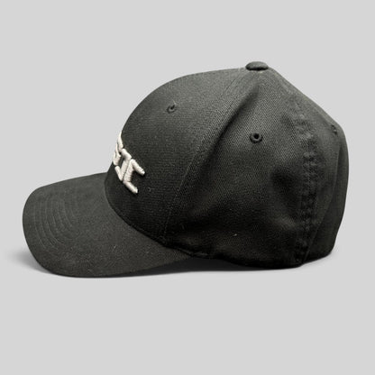 Raree Finds black Yupoong Flexfit cap with raised white CSI embroidery on the front, side profile view.
