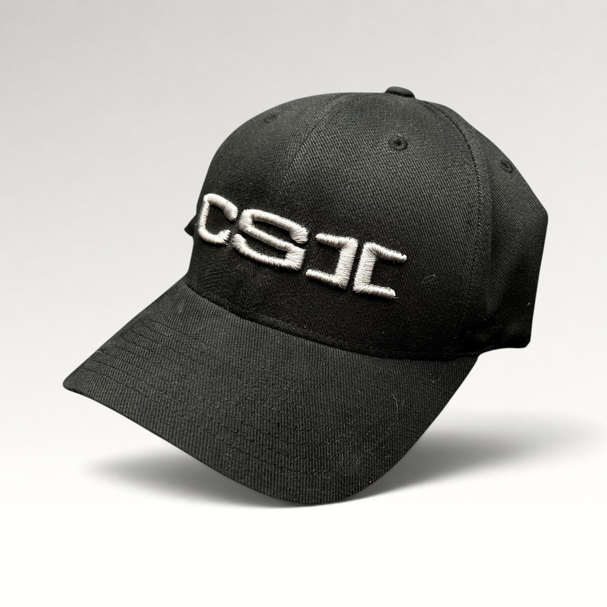 Raree Finds black Yupoong Flexfit cap with raised white CSI embroidery on the front panel