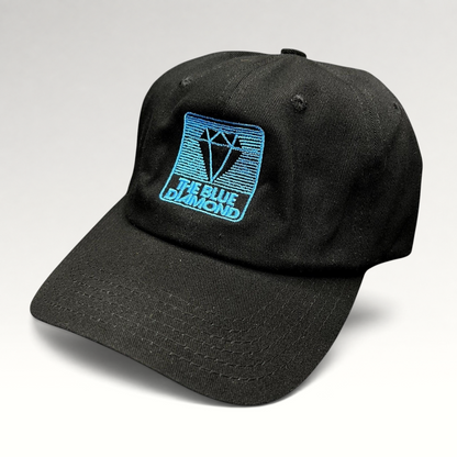 Raree Finds black cotton strapback hat with a blue embroidered diamond logo, featuring a vintage skiwear aesthetic.