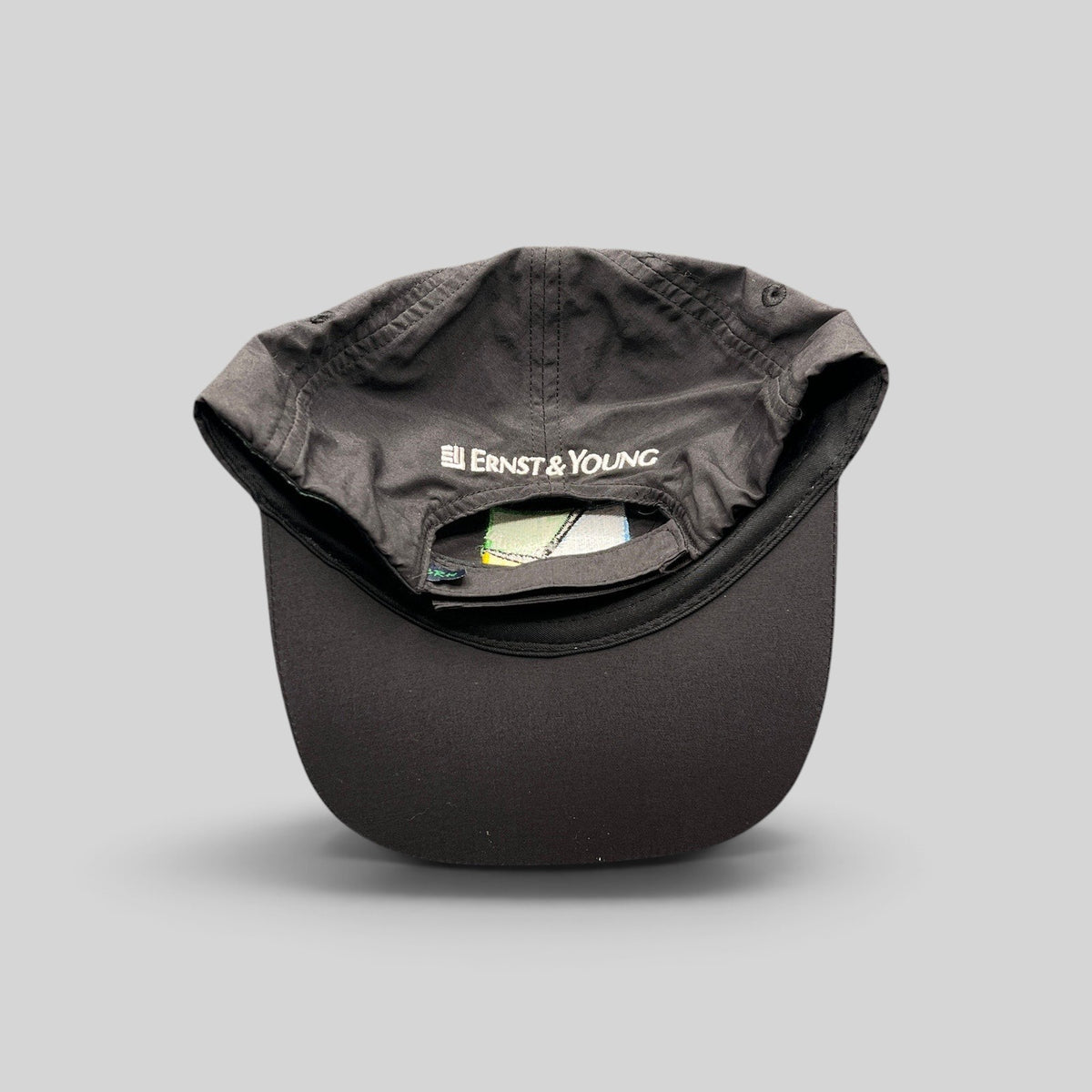 Raree Finds black unstructured strapback hat with Ernst & Young embroidery on the back panel