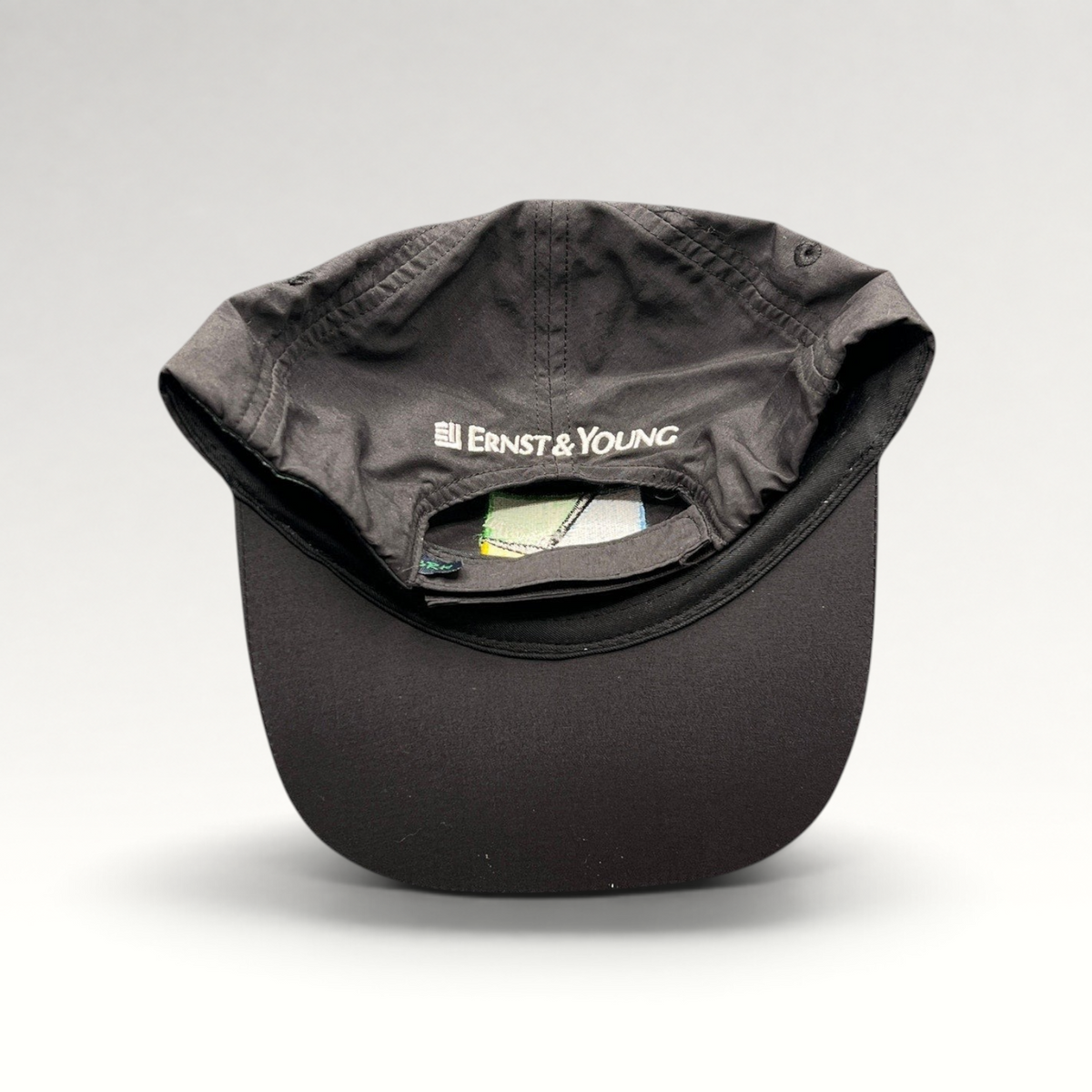 Raree Finds black unstructured strapback hat with Ernst & Young embroidery on the back panel