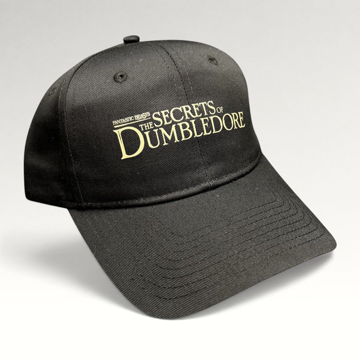 Raree Finds black snapback hat featuring metallic gold embroidered Fantastic Beasts The Secrets of Dumbledore logo