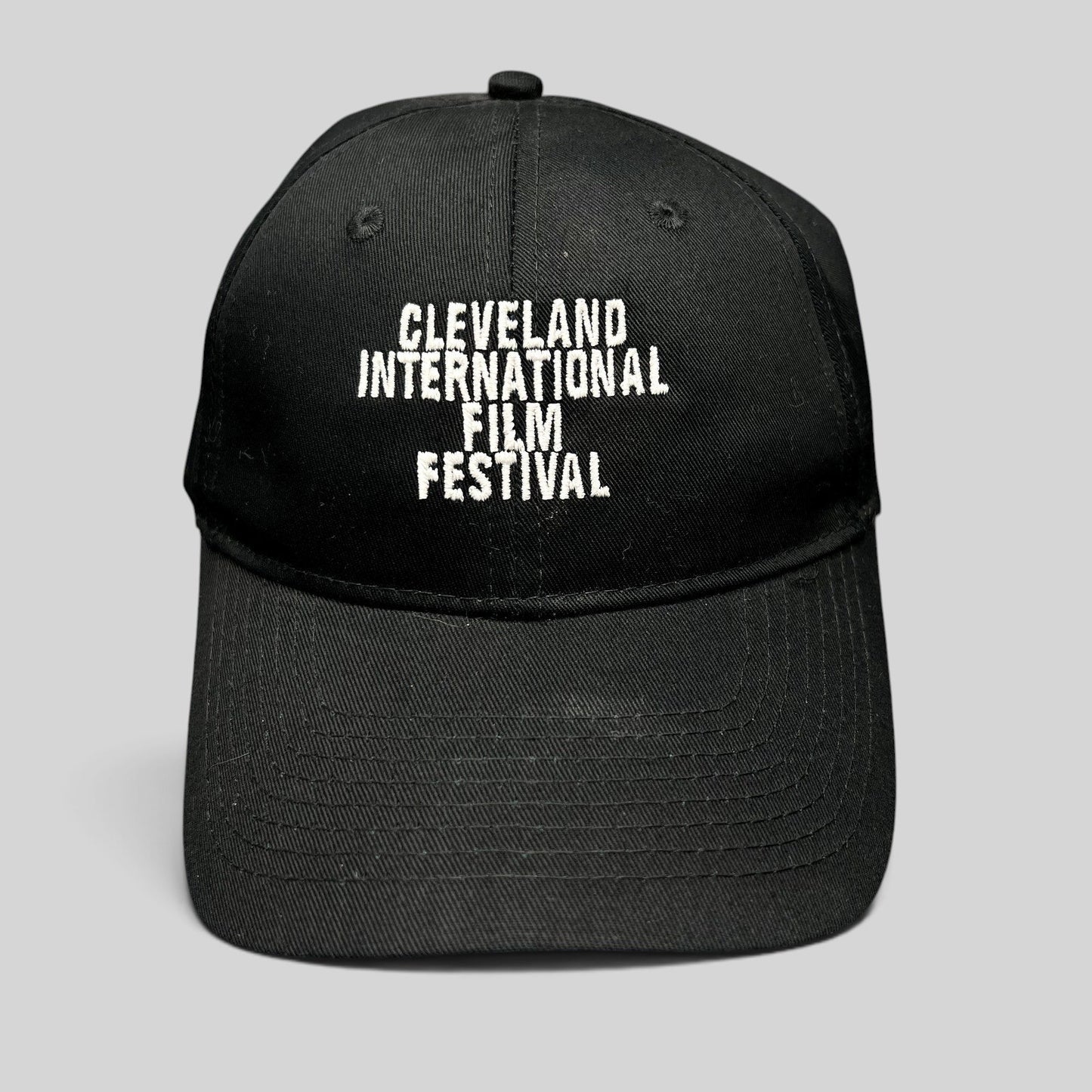 Raree Finds black strapback hat with white embroidered Cleveland International Film Festival lettering on the front