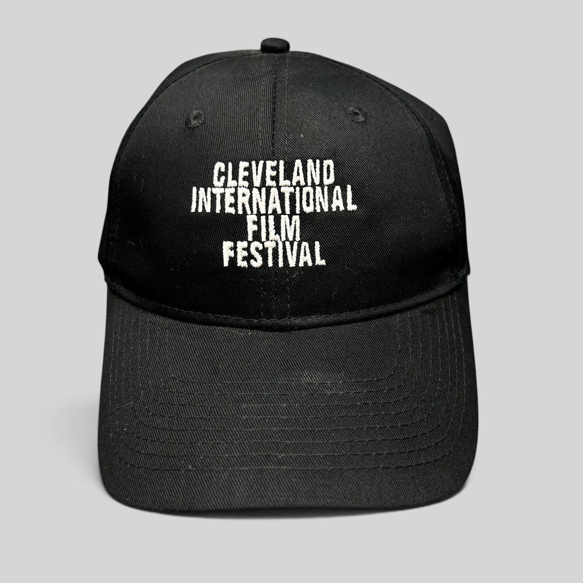 Raree Finds black strapback hat with white embroidered Cleveland International Film Festival lettering on the front