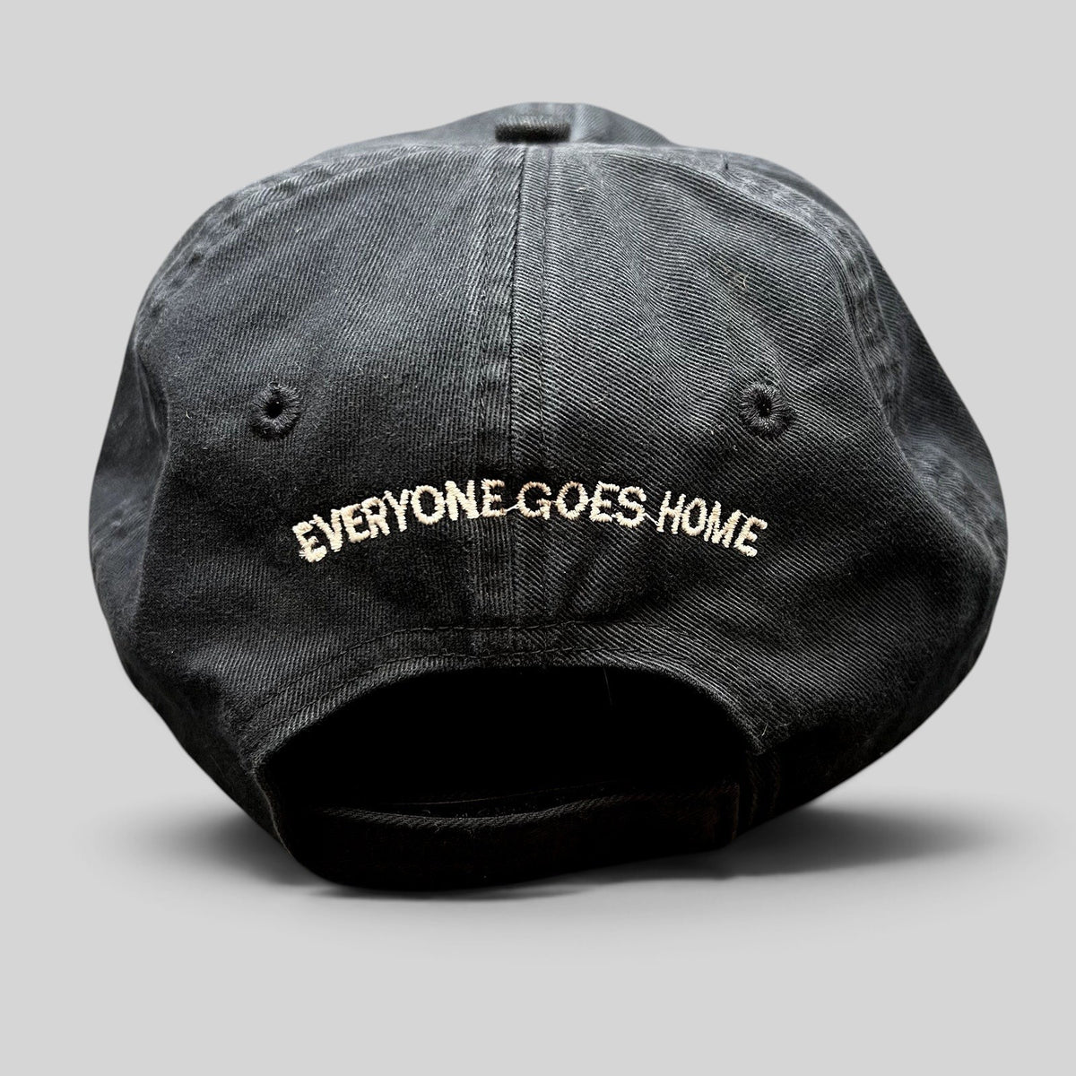 Raree Finds black cotton strapback hat with Everyone Goes Home embroidered on the back in white thread
