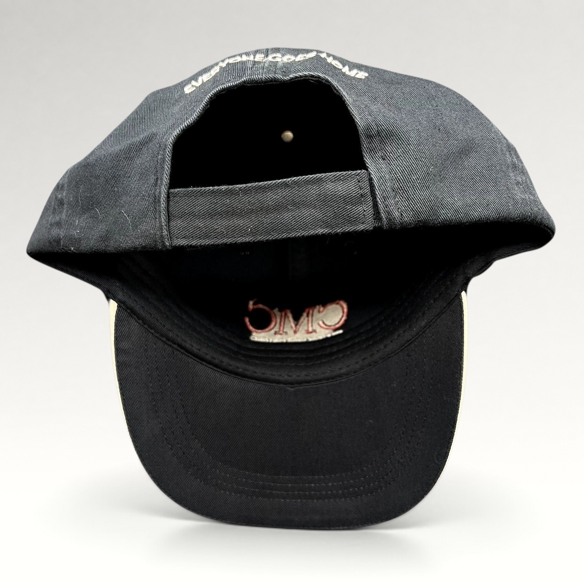 Raree Finds black cotton strapback hat with Everyone Goes Home embroidery on the back and CMC logo on the interior