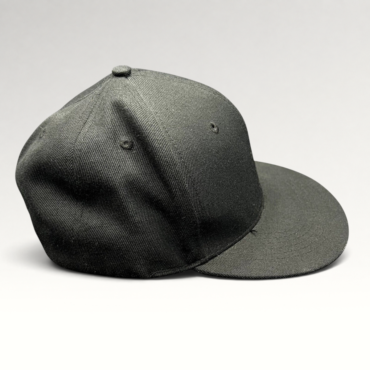 Raree Finds black Fits snapback hat with flat brim and structured crown, side profile view.