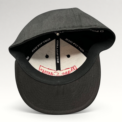 Raree Finds black Flexfit 210 fitted cap showing interior branding and structured crown construction