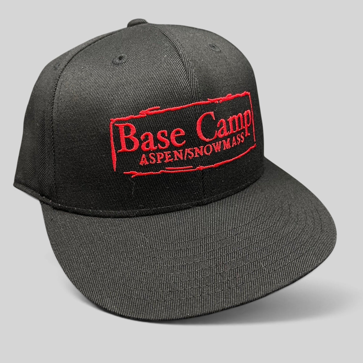 Raree Finds black Flexfit 210 fitted cap with red embroidered Base Camp Aspen Snowmass logo on the front crown.