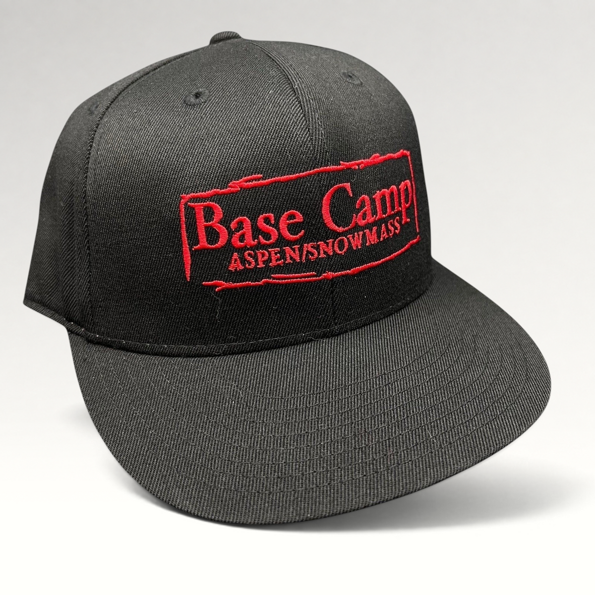 Raree Finds black Flexfit 210 fitted cap with red embroidered Base Camp Aspen Snowmass logo on the front crown.