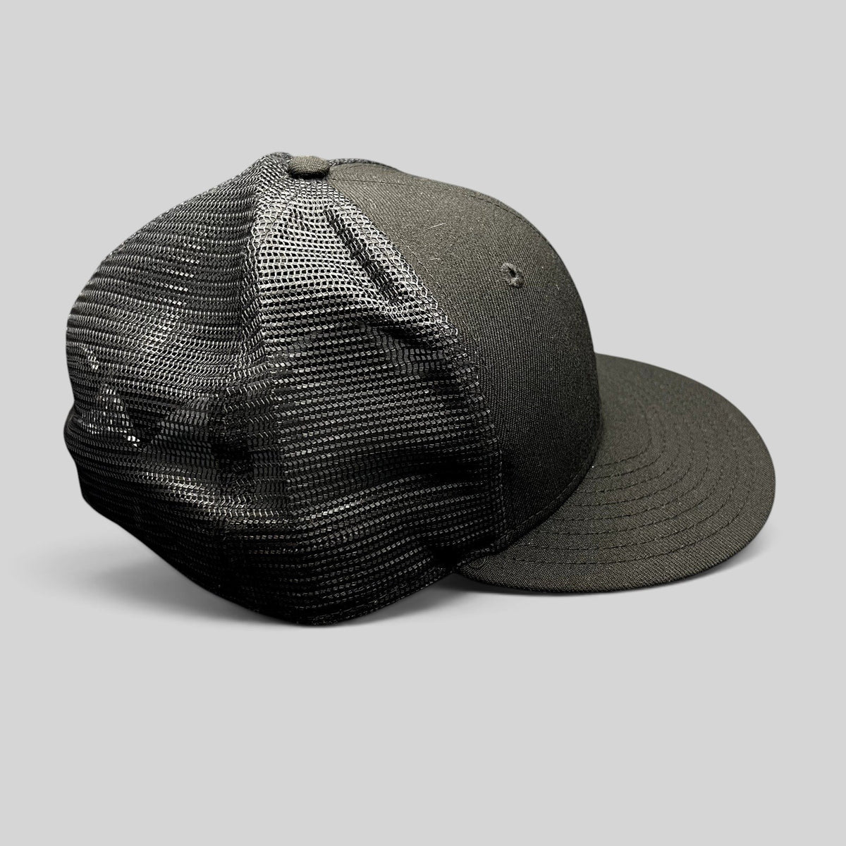 Raree Finds black New Era 59FIFTY fitted trucker hat with a structured high crown, flat brim, and breathable mesh back.