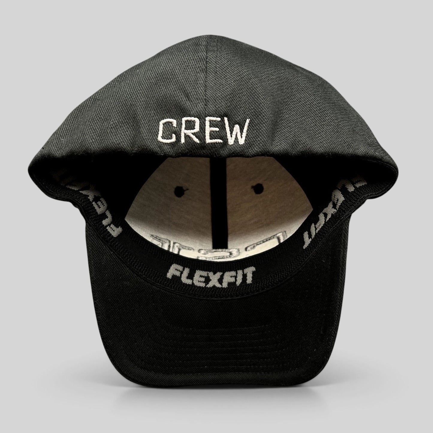 Raree Finds black Yupoong Flexfit hat with CREW embroidered in gray on the back interior sweatband