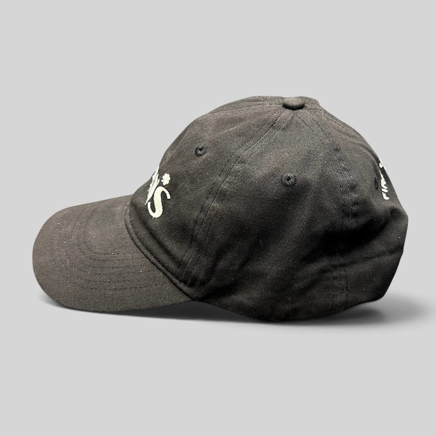 Raree Finds black unstructured strapback hat with white embroidered Flynn’s Irish pub logo and shamrock detail
