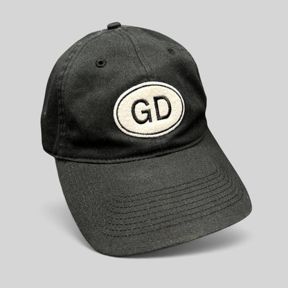 Raree Finds black cotton strapback hat featuring an oval GD logo patch on the front