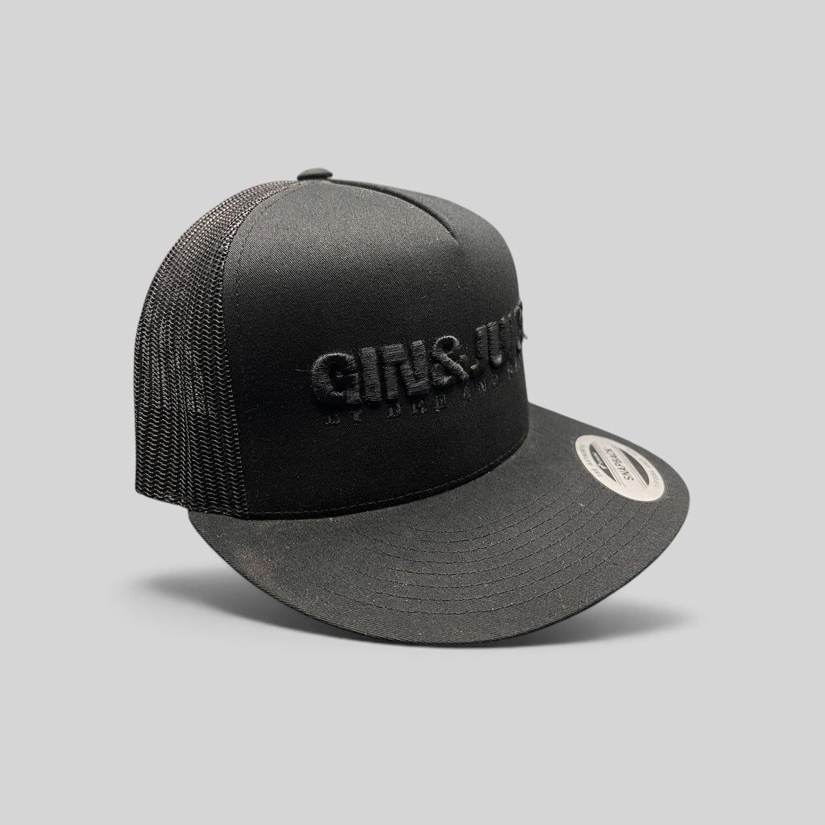 Raree Finds black Gin & Juice snapback hat with puff embroidery, mesh back, and flat brim on a dark background.