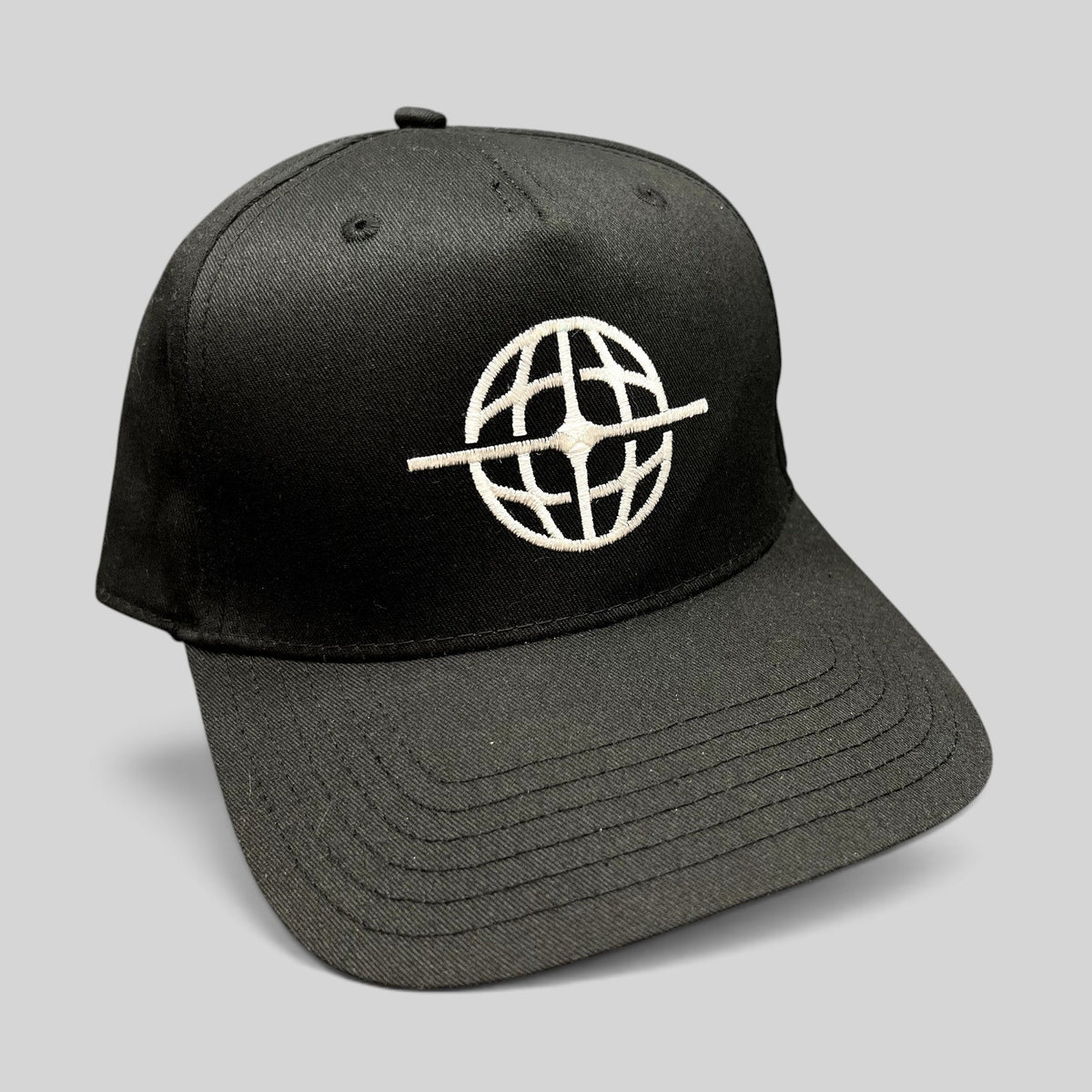Raree Finds black snapback hat with white embroidered globe logo on the front, featuring a structured six-panel design.