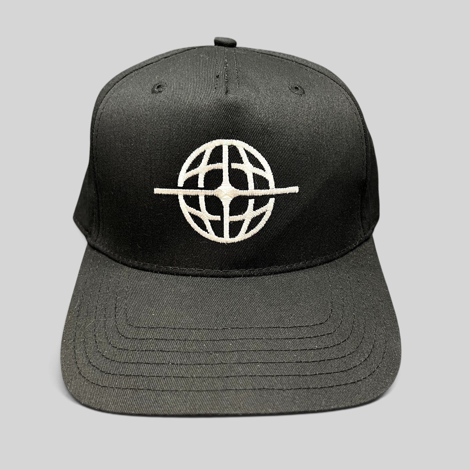 Raree Finds black snapback hat with white embroidered globe logo on the front, featuring a structured six-panel design.