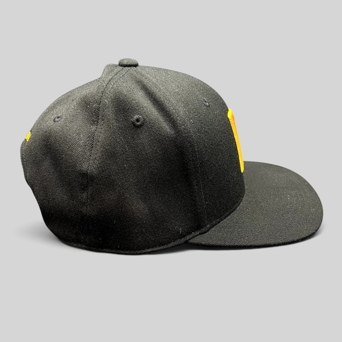 Raree Finds black Yupoong 110 Flexfit snapback hat with a gold embroidered P logo on the structured crown