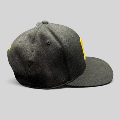 Raree Finds black Yupoong 110 Flexfit snapback hat with a gold embroidered P logo on the structured crown