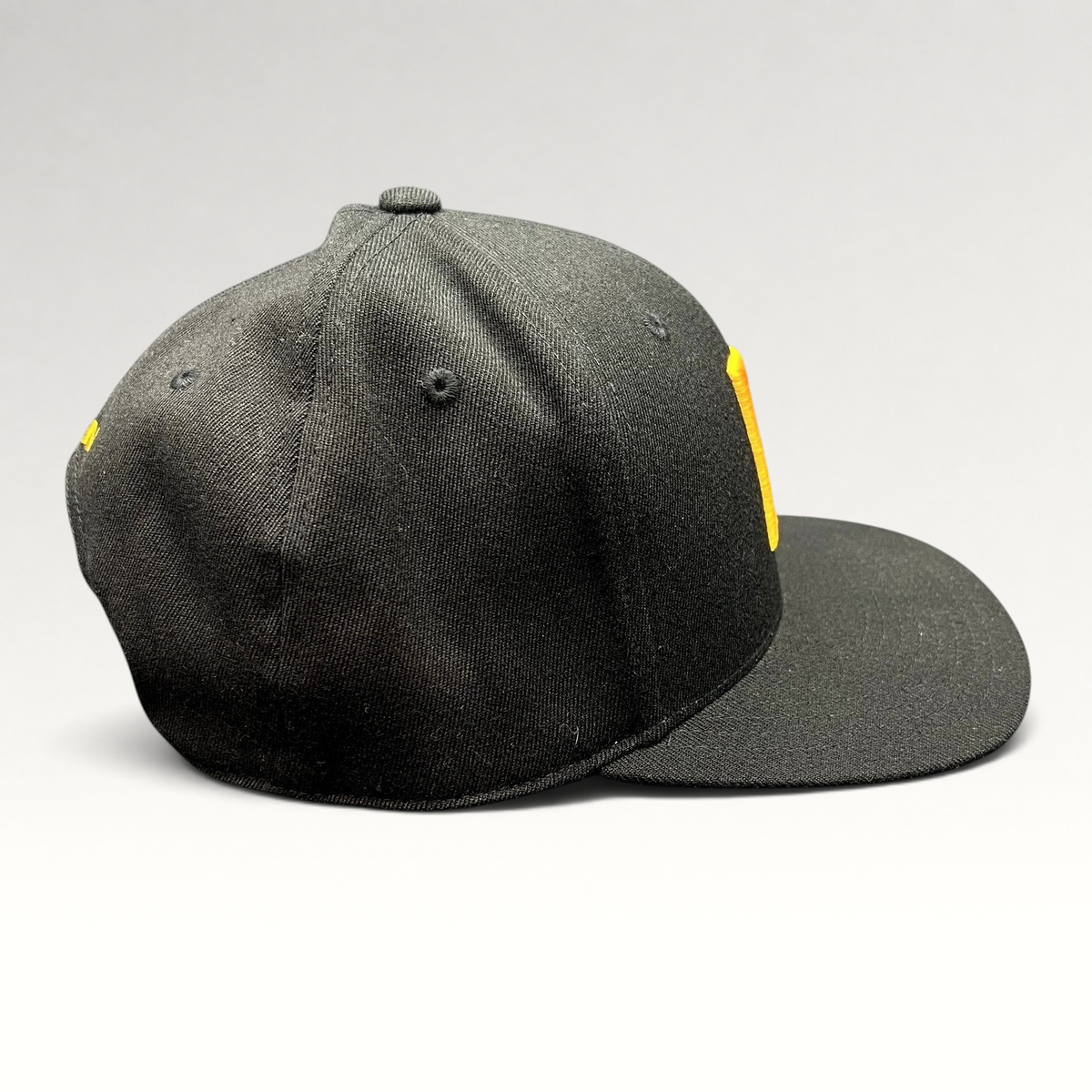 Raree Finds black Yupoong 110 Flexfit snapback hat with a gold embroidered P logo on the structured crown