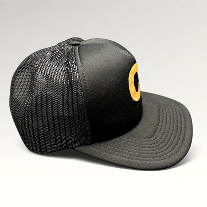 Raree Finds Cloud 10 C10 black and gold trucker hat with foam front, mesh back panels, and structured high crown.