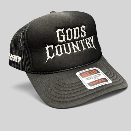 Raree Finds black foam trucker hat with white gothic God's Country embroidery, mesh back, and adjustable snapback.