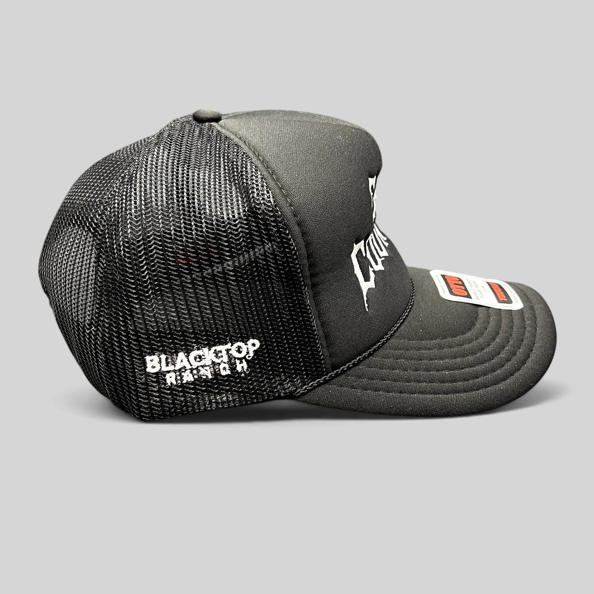 Raree Finds black trucker hat with white gothic embroidery, mesh back, and rope detail on a foam-front OTTO cap.