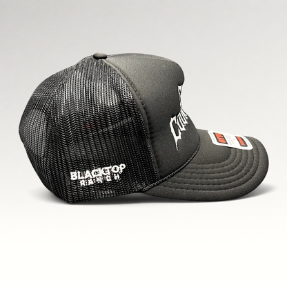 Raree Finds black trucker hat with white gothic embroidery, mesh back, and rope detail on a foam-front OTTO cap.