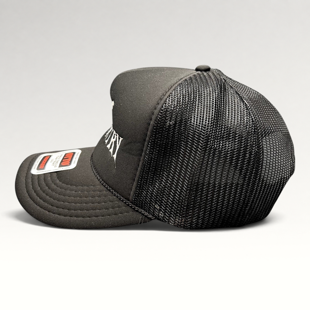 Raree Finds black foam trucker hat with white gothic God's Country embroidery, mesh back, and rope detail.