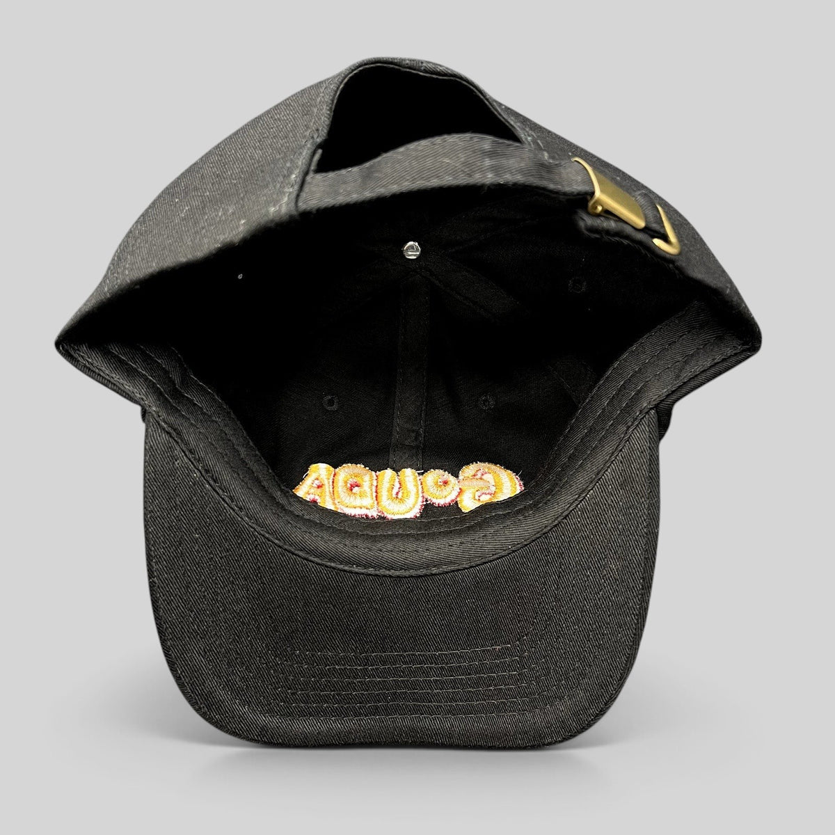 Raree Finds black cotton strapback hat with embroidered Gouda logo visible from the inside, featuring a metal buckle.