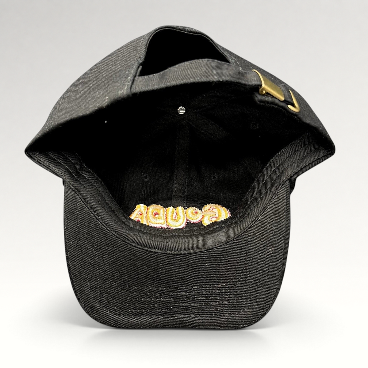 Raree Finds black cotton strapback hat with embroidered Gouda logo visible from the inside, featuring a metal buckle.