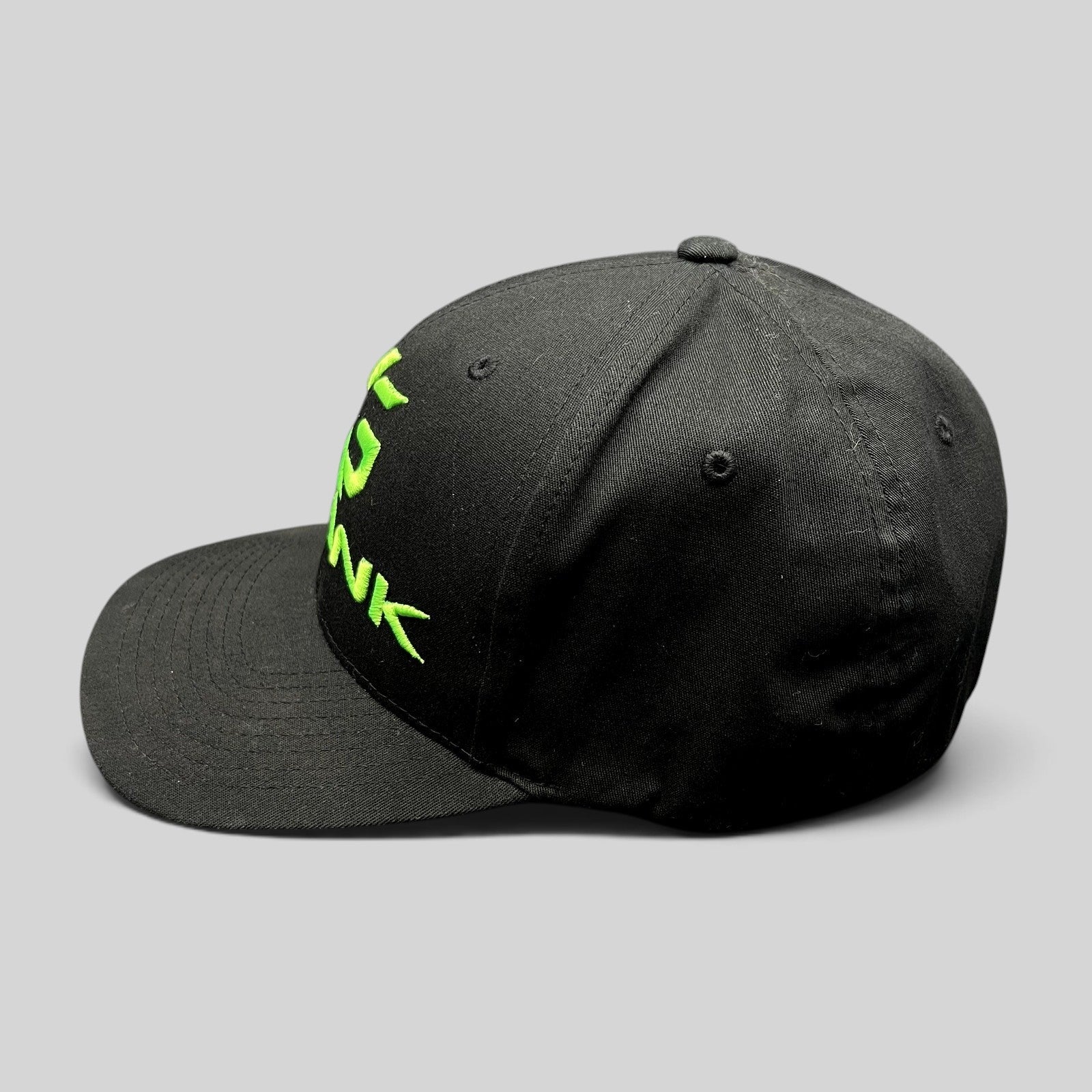 Raree Finds black Krank Golf Flexfit cap with bright green embroidered logo on the side profile