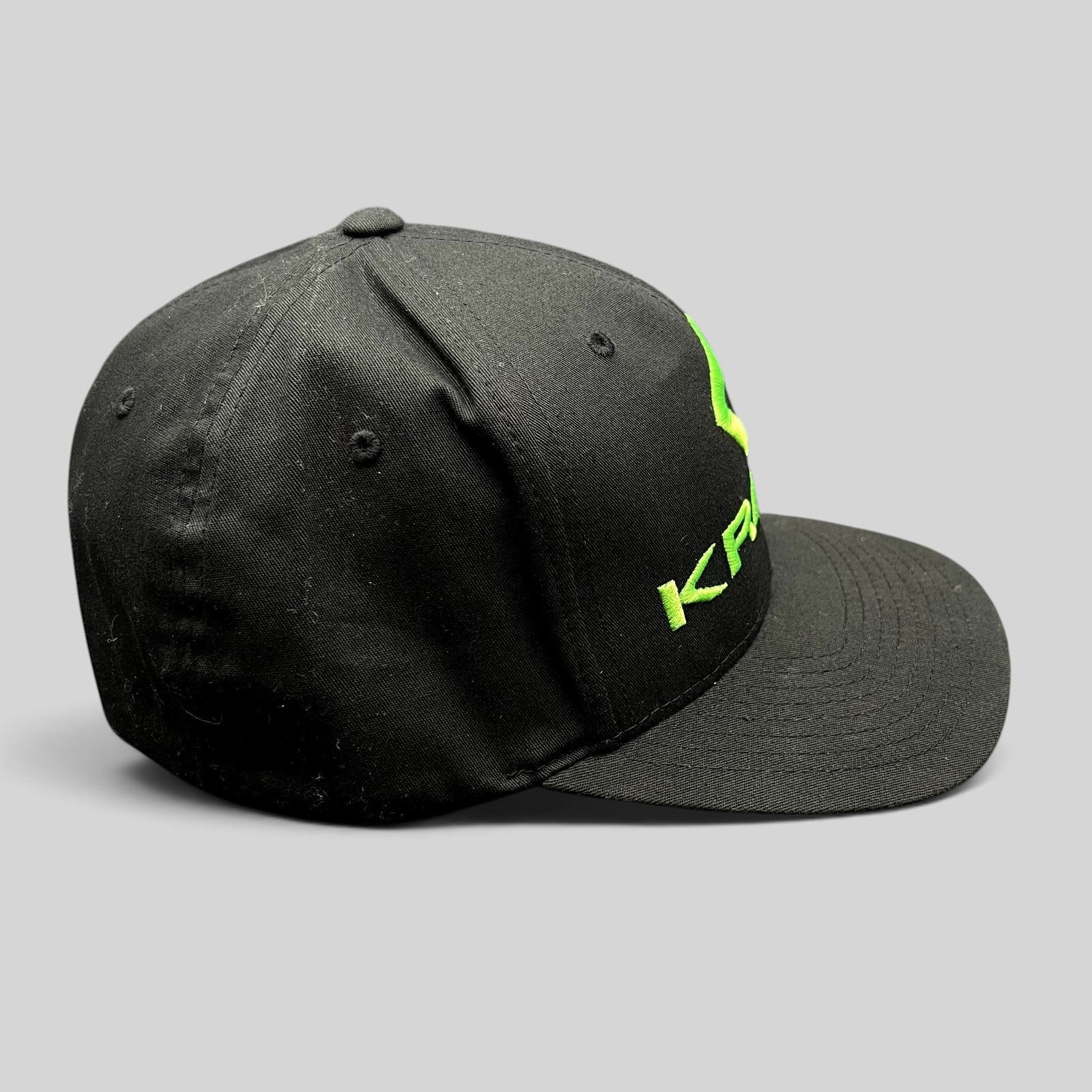 Raree Finds black Krank Golf Flexfit cap with bright green embroidered logo on the side, size L/XL.
